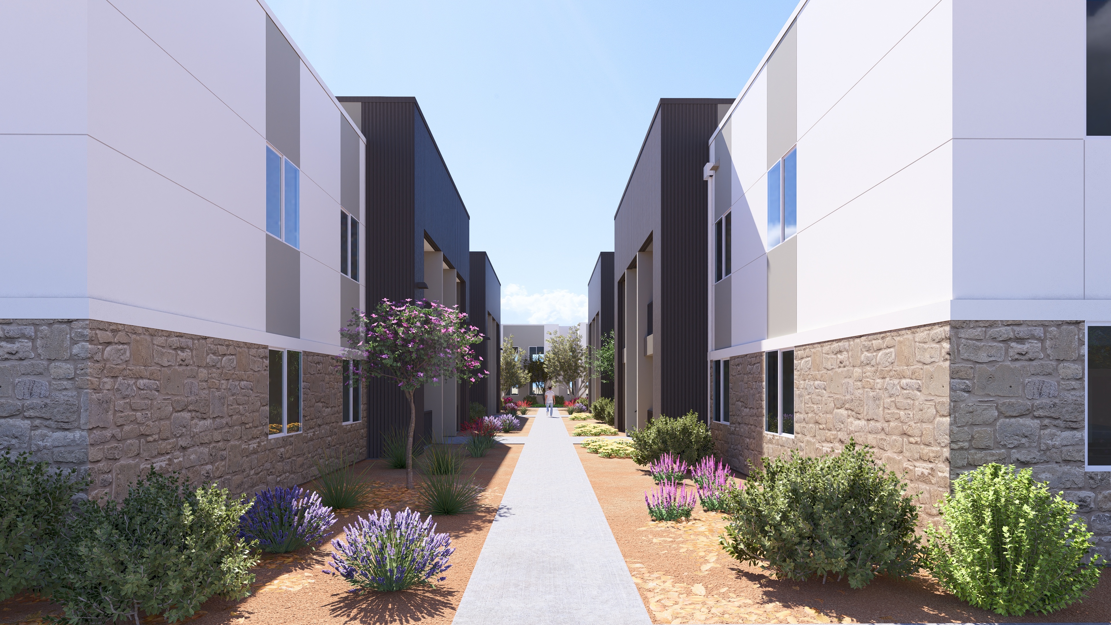 A modern residential area with a pathway and buildings on either side.